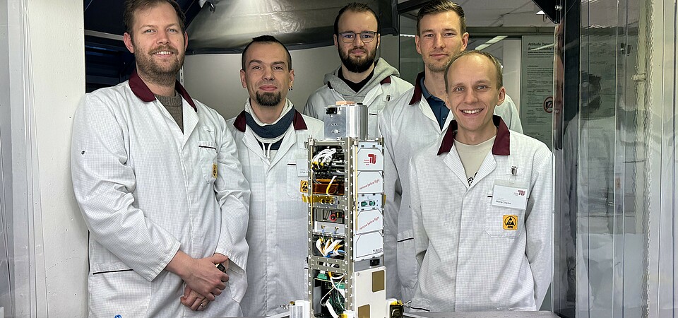 The QUICK³ flight model in the integration laboratory at the Department of Space Technology with the development team from the TU Berlin. The QUICK³ flight model in the integration laboratory at the Department of Space Technology with the development team from the TU Berlin.