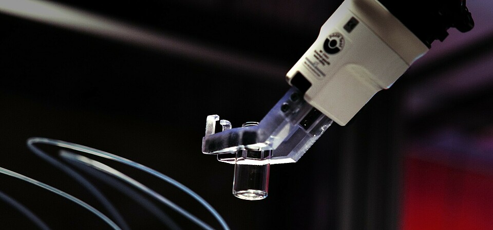 robotic arm A robotic arm precisely moves an empty sample container back and forth between automated workstations.